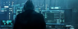 hacker in dimly lit room